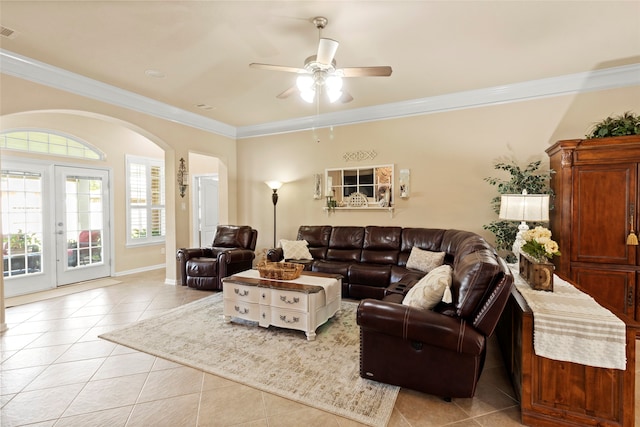 tiled living room with ceiling fan, french doors, and ornamental molding