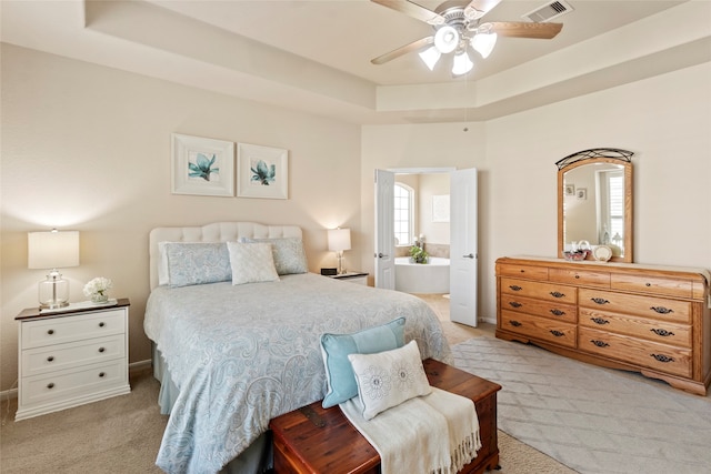 bedroom featuring light colored carpet, ceiling fan, and a raised ceiling