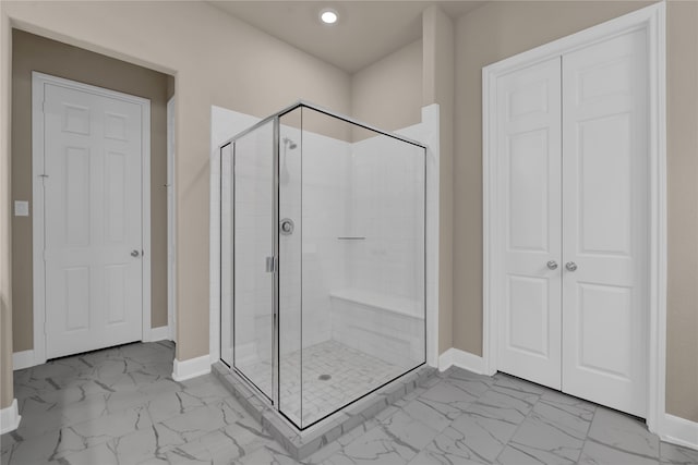 bathroom with a shower with door