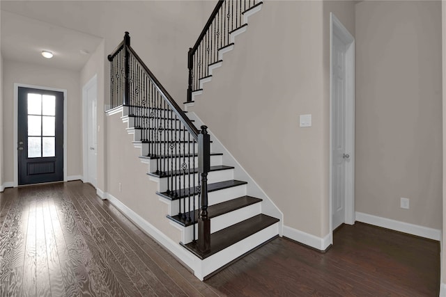 foyer with dark hardwood / wood-style floors