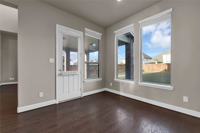 spare room featuring dark wood-type flooring