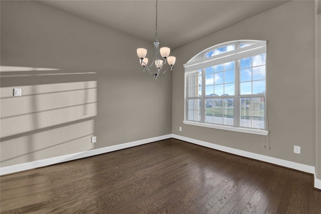 unfurnished dining area with a notable chandelier and dark hardwood / wood-style floors