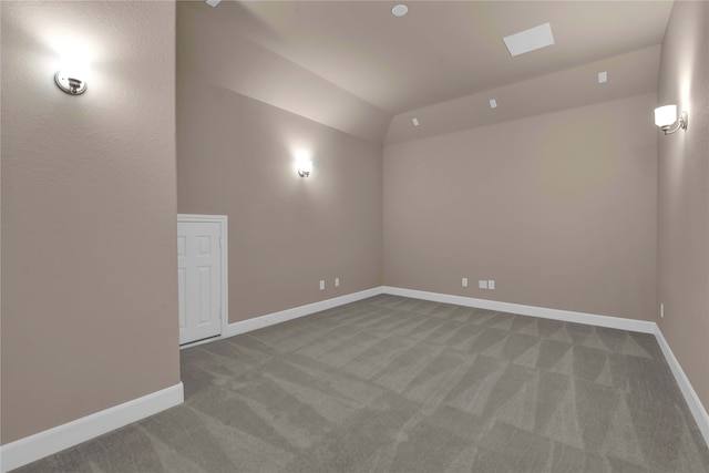 carpeted empty room featuring lofted ceiling