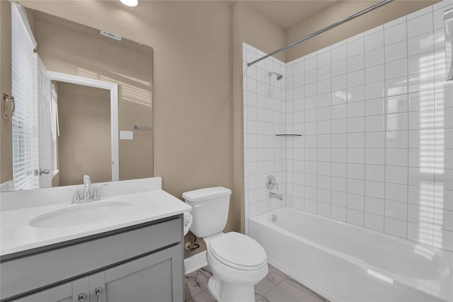 full bathroom with tiled shower / bath, toilet, and vanity