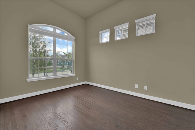 unfurnished room featuring dark hardwood / wood-style floors and plenty of natural light