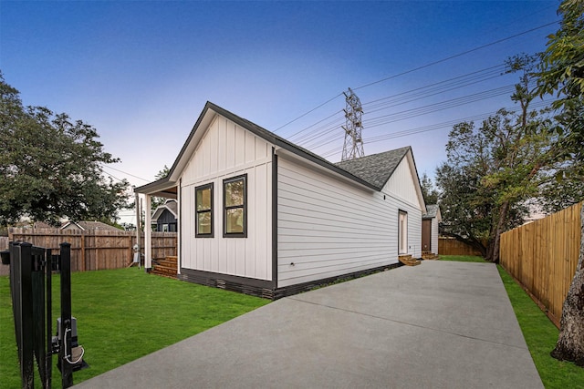 view of property exterior featuring a patio area and a yard