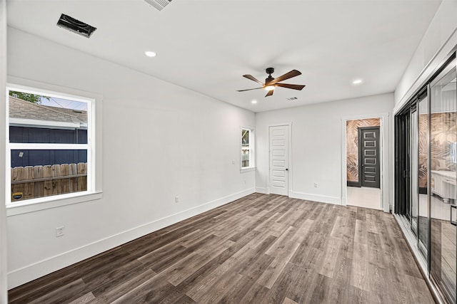 2714 Hardy St, Houston, TX 77009 - unfurnished bedroom featuring wood finished floors, recessed lighting, a ceiling fan, and two closets