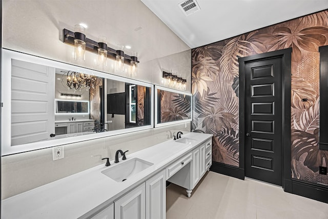 2714 Hardy St, Houston, TX 77009 - full bathroom with wallpapered walls, a chandelier, double vanity, and tile patterned flooring