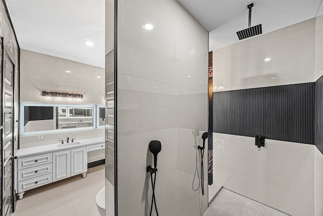 bathroom featuring tile patterned floors, walk in shower, and vanity