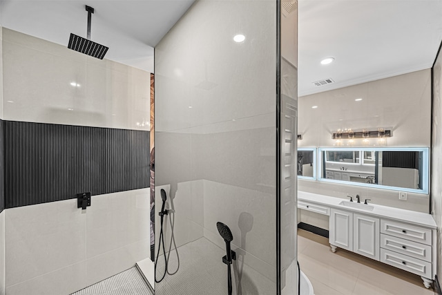 bathroom featuring vanity, a shower, and tile patterned floors