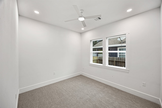 carpeted spare room featuring ceiling fan