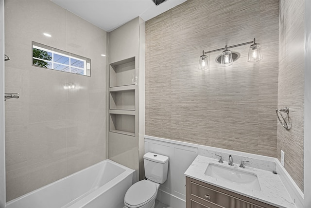 full bathroom featuring toilet, vanity, and tub / shower combination