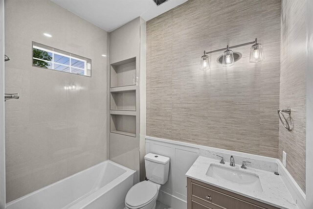 2714 Hardy St, Houston, TX 77009 - bathroom featuring  shower combination, vanity, and wainscoting