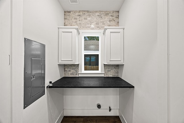 2714 Hardy St, Houston, TX 77009 - kitchen featuring electric panel, white cabinets, and dark countertops