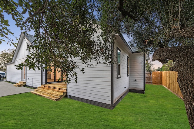 view of side of property with a yard