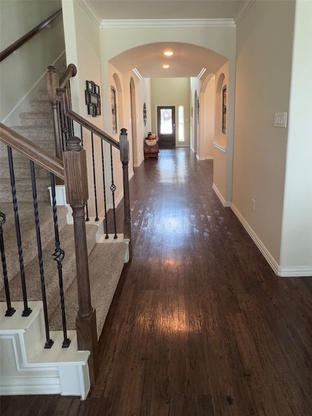 hallway featuring dark hardwood / wood-style floors and ornamental molding