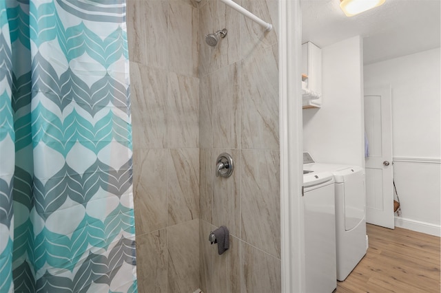 bathroom featuring separate washer and dryer, hardwood / wood-style floors, and a shower with shower curtain