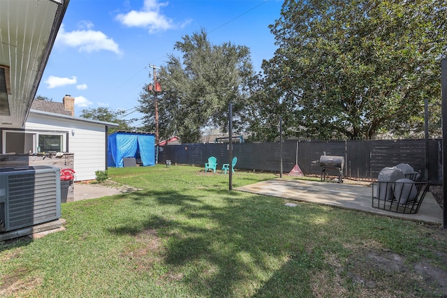 view of yard with central air condition unit and a patio area