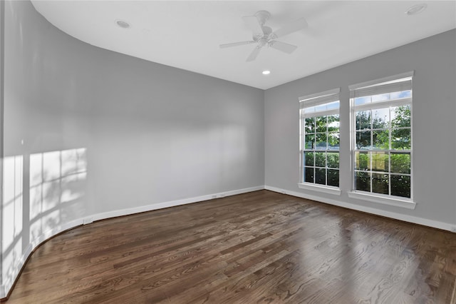 spare room with ceiling fan and dark hardwood / wood-style floors