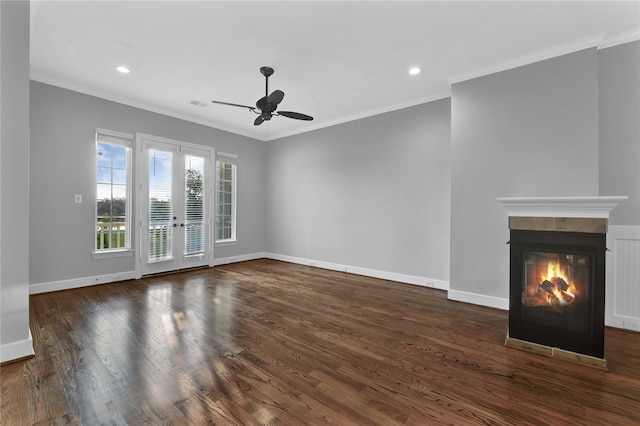 unfurnished living room with dark hardwood / wood-style flooring, ceiling fan, and ornamental molding