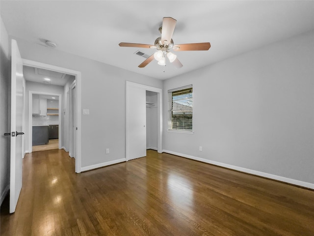 unfurnished bedroom featuring ceiling fan and dark hardwood / wood-style flooring