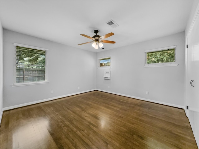 unfurnished room featuring ceiling fan and dark wood-type flooring