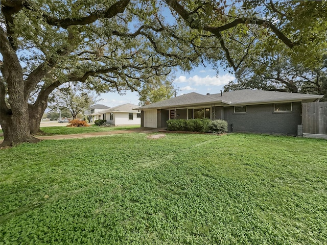 back of property with a lawn and a garage