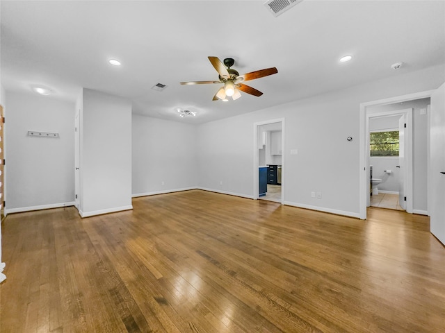 unfurnished living room featuring ceiling fan and hardwood / wood-style flooring