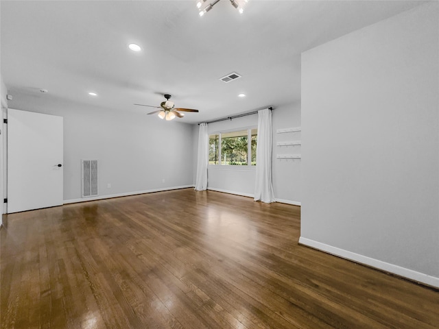 unfurnished room featuring ceiling fan and dark wood-type flooring