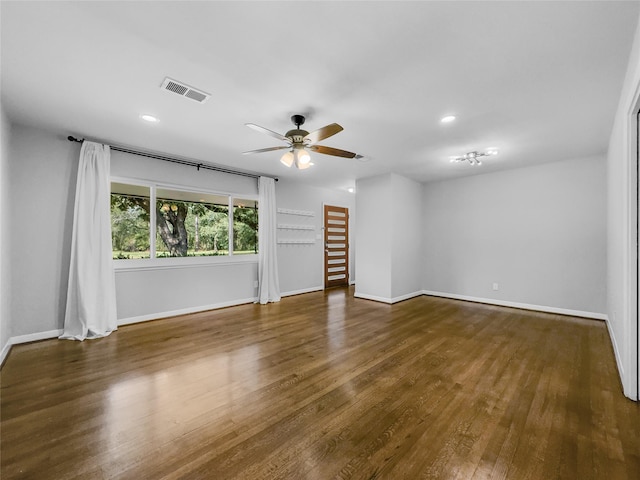 spare room featuring ceiling fan and dark wood-type flooring