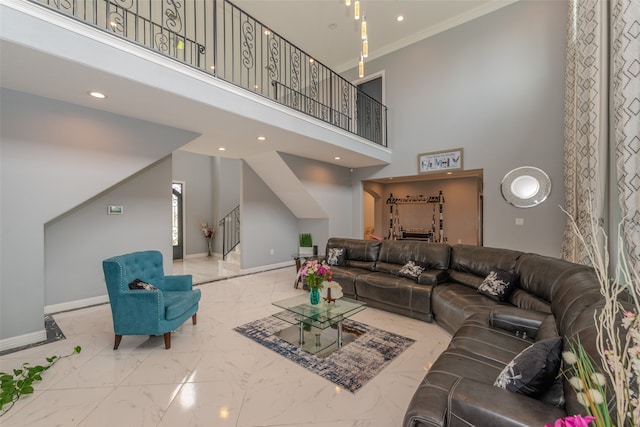 living room featuring a towering ceiling and crown molding