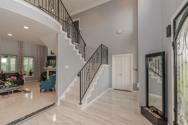 foyer entrance featuring a towering ceiling