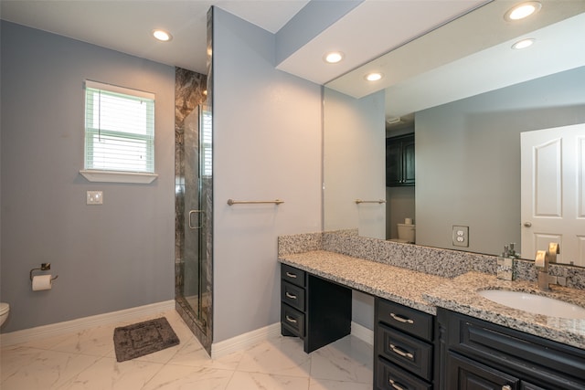 bathroom featuring toilet, vanity, and walk in shower