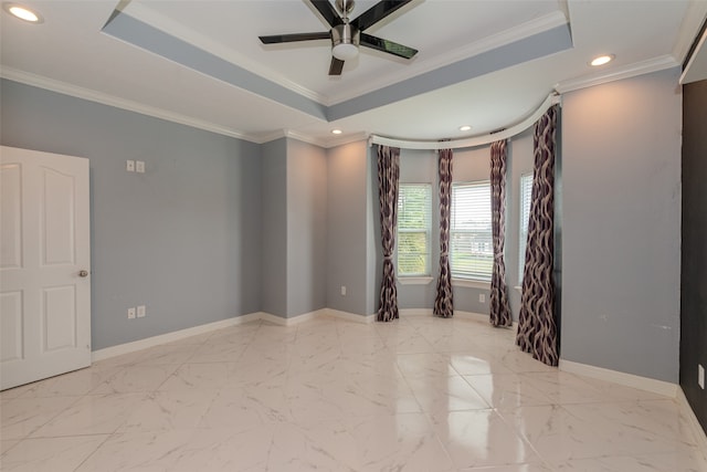 spare room featuring ceiling fan, crown molding, and a tray ceiling