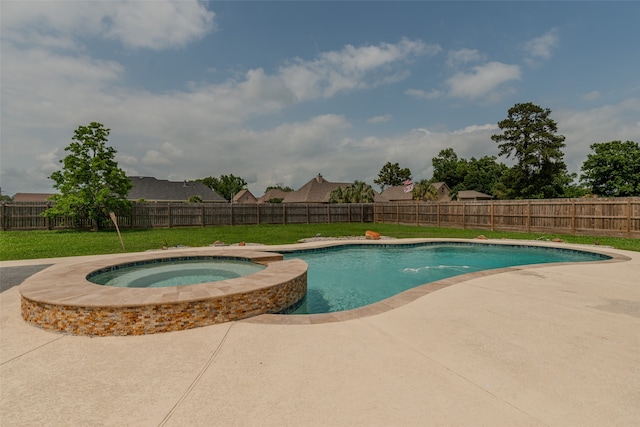 view of swimming pool with a patio, a lawn, and an in ground hot tub