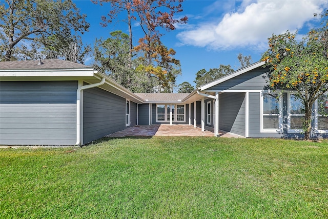 back of house featuring a patio area and a yard