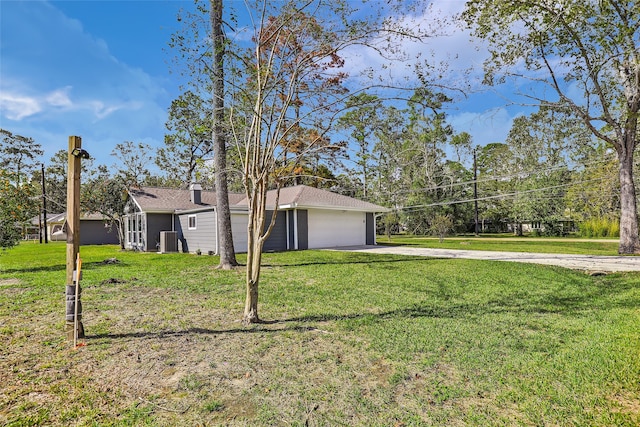 exterior space featuring a garage and a front lawn