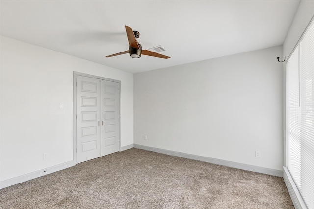 unfurnished bedroom with ceiling fan, a closet, and light colored carpet