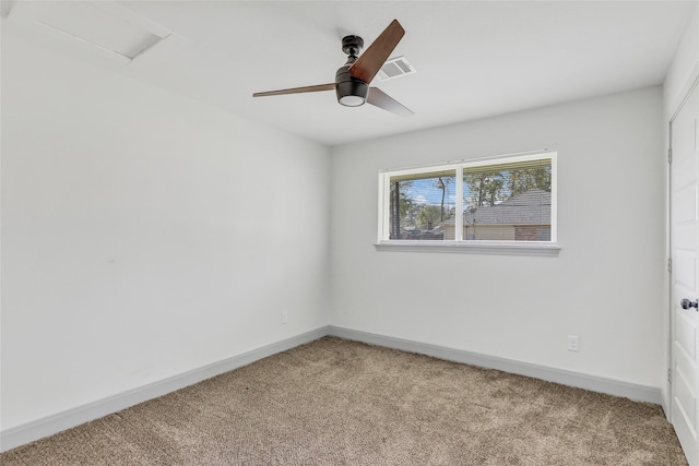 empty room featuring ceiling fan and light carpet