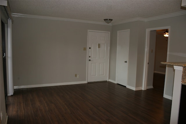 unfurnished room featuring dark hardwood / wood-style flooring, a textured ceiling, and crown molding