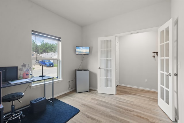 home office with french doors and light wood-type flooring