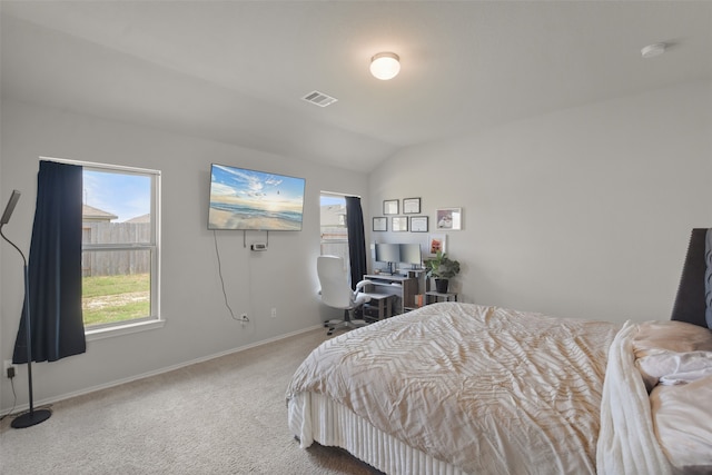 bedroom featuring vaulted ceiling and carpet floors