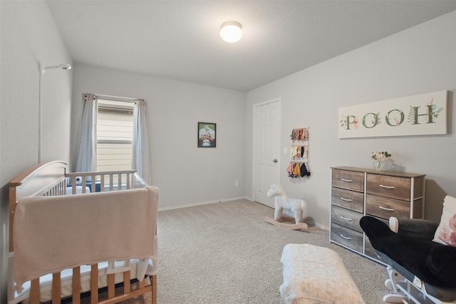 carpeted bedroom with a crib