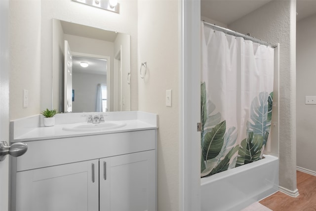 bathroom featuring hardwood / wood-style floors, vanity, and shower / bathtub combination with curtain