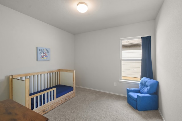 carpeted bedroom with a nursery area