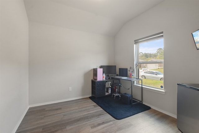 home office with hardwood / wood-style flooring and vaulted ceiling