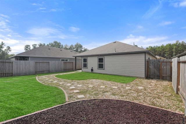 rear view of house with a lawn