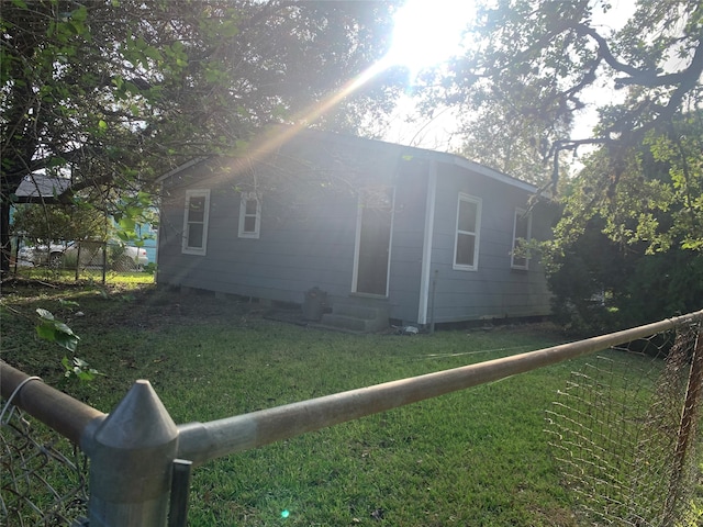 view of home's exterior with a yard