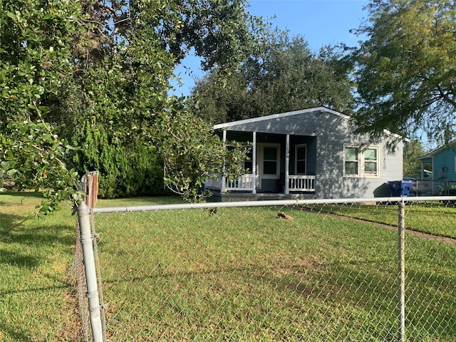 view of front of property with covered porch and a front yard