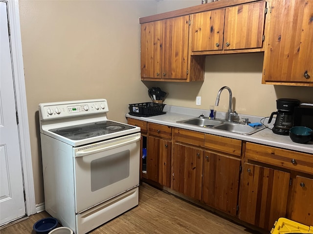 kitchen with white electric stove, dark hardwood / wood-style flooring, and sink